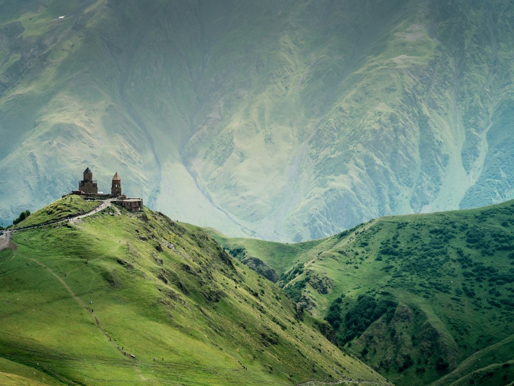 Cycling through rural Georgia reveals quiet monasteries shadowed by the imposing Caucasus Mountains.