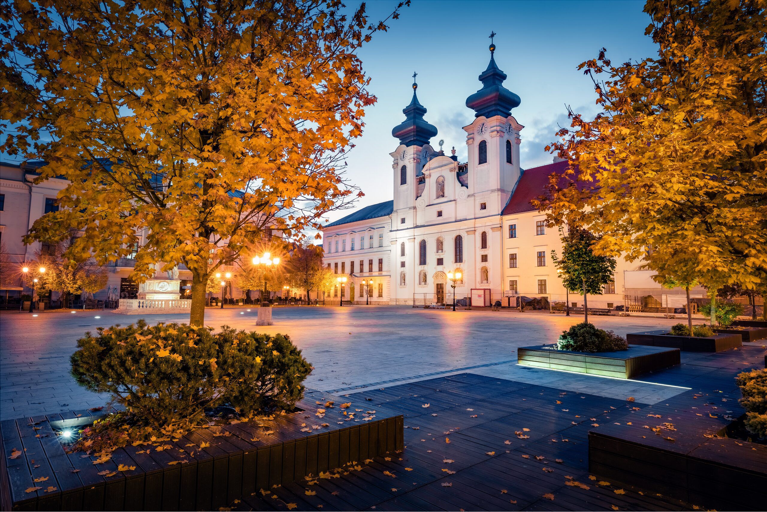 The baroque Benedictine church on Széchenyi Square in Győr at dusk