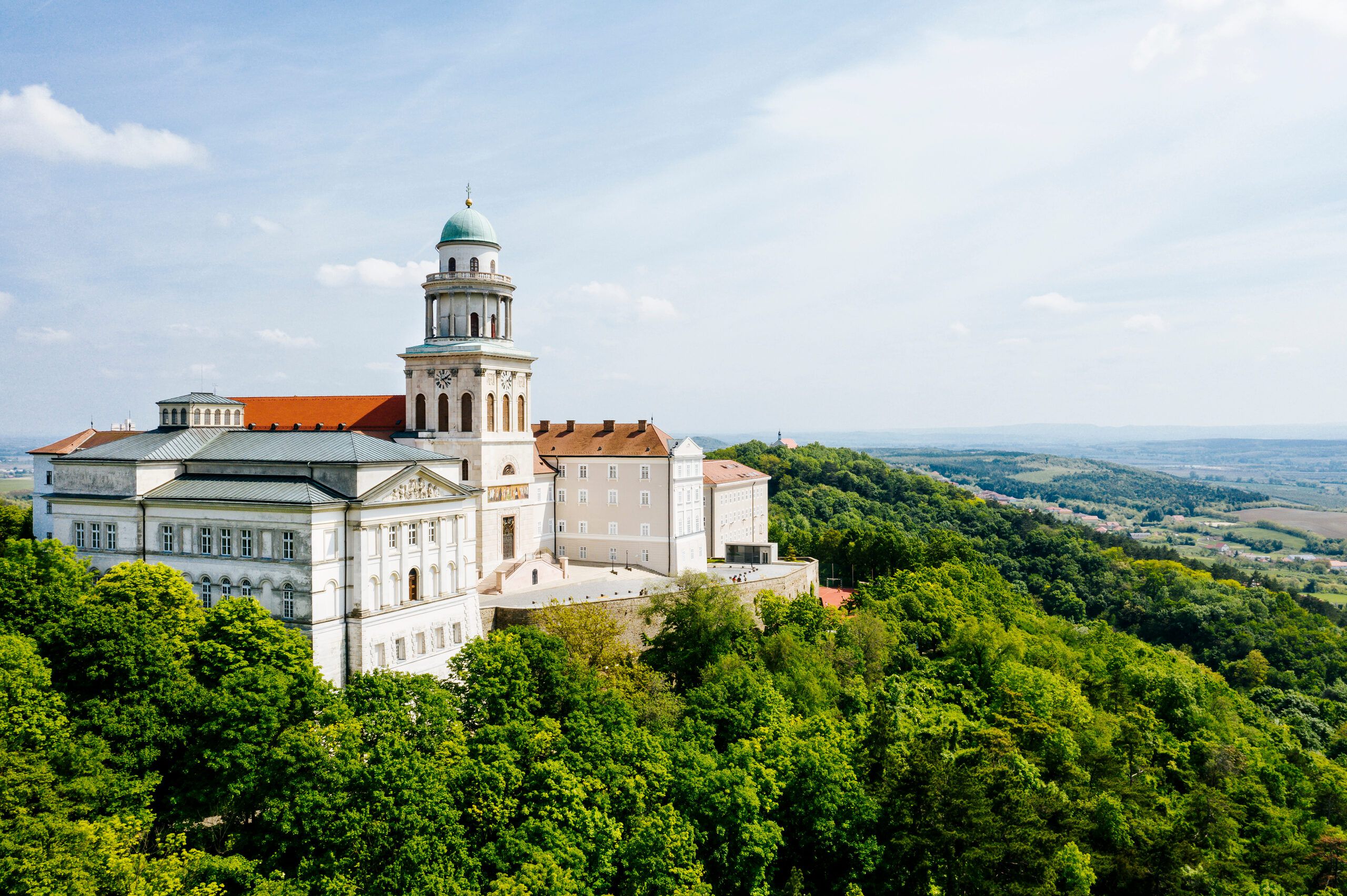 Pannonhalma Abbey on its wooded hilltop above the surrounding plain