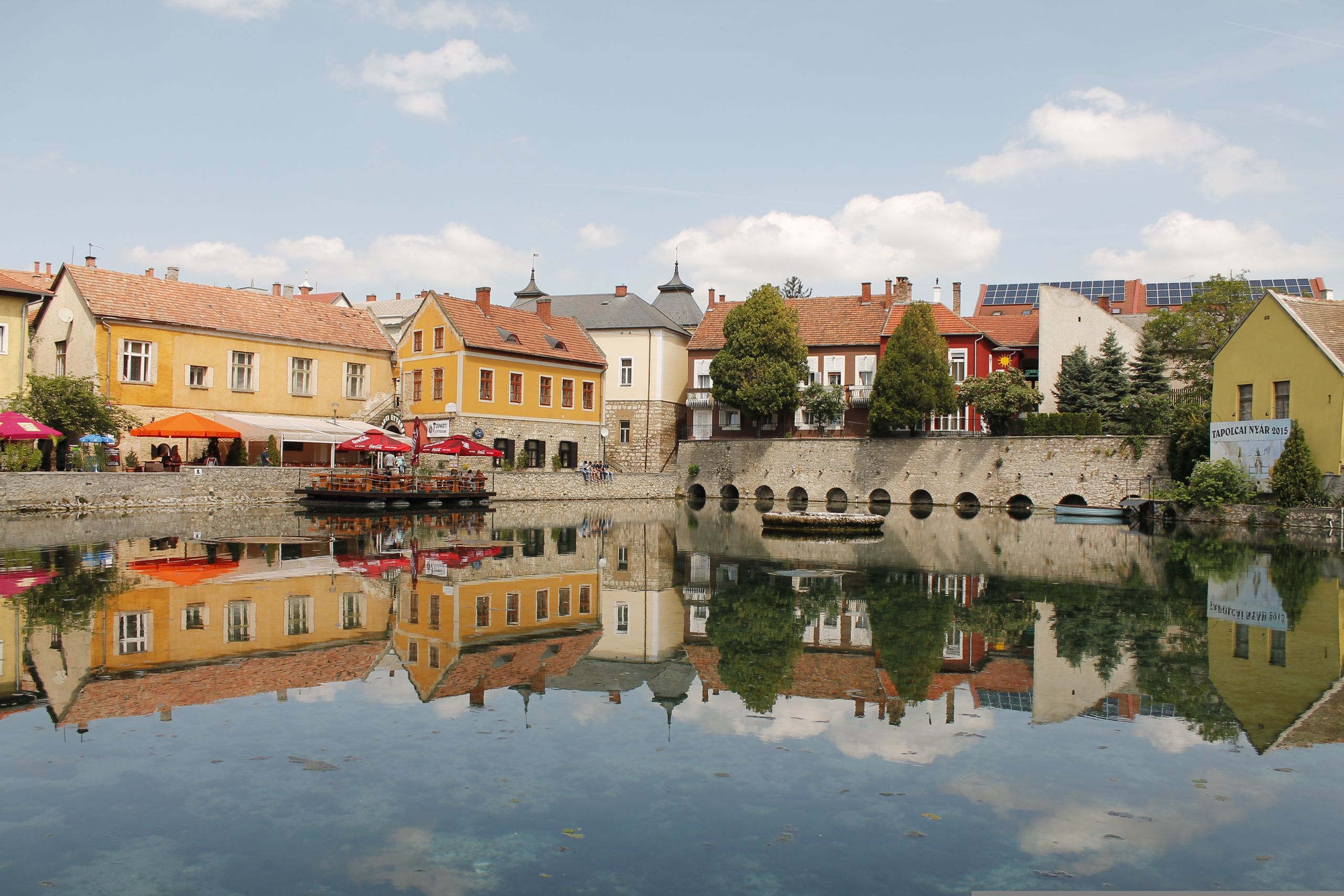 Colourful houses reflected in the Mill Lake in Tapolca