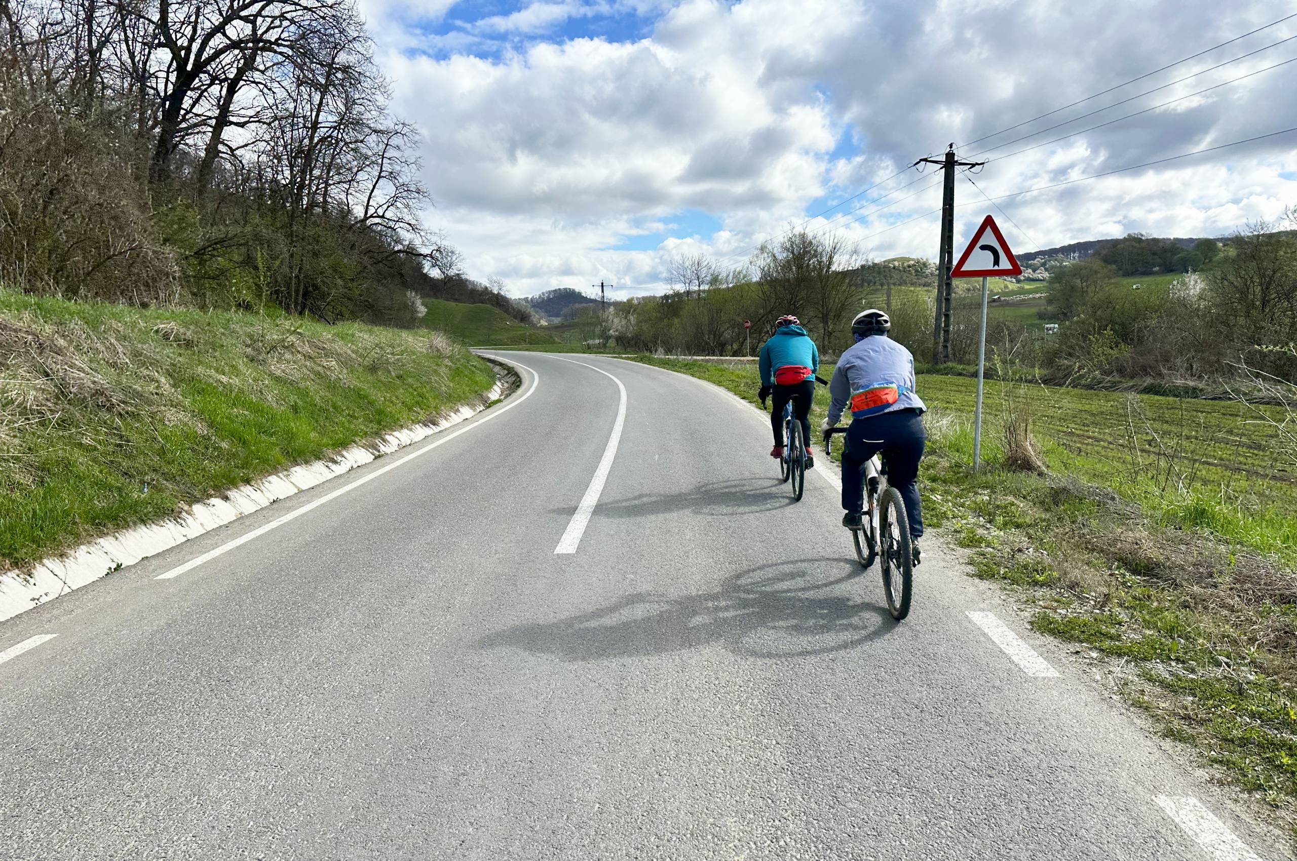 Pair of riders pedalling through the rolling hills of Transylvania.